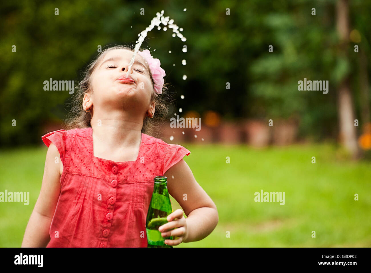 Little girl spitting water Stock Photo