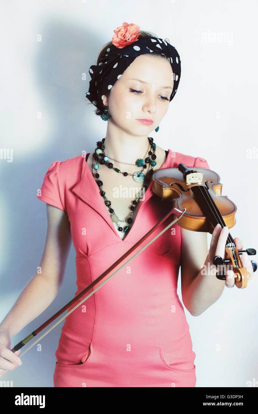 Portrait of young woman with violin on white background Stock Photo - Alamy