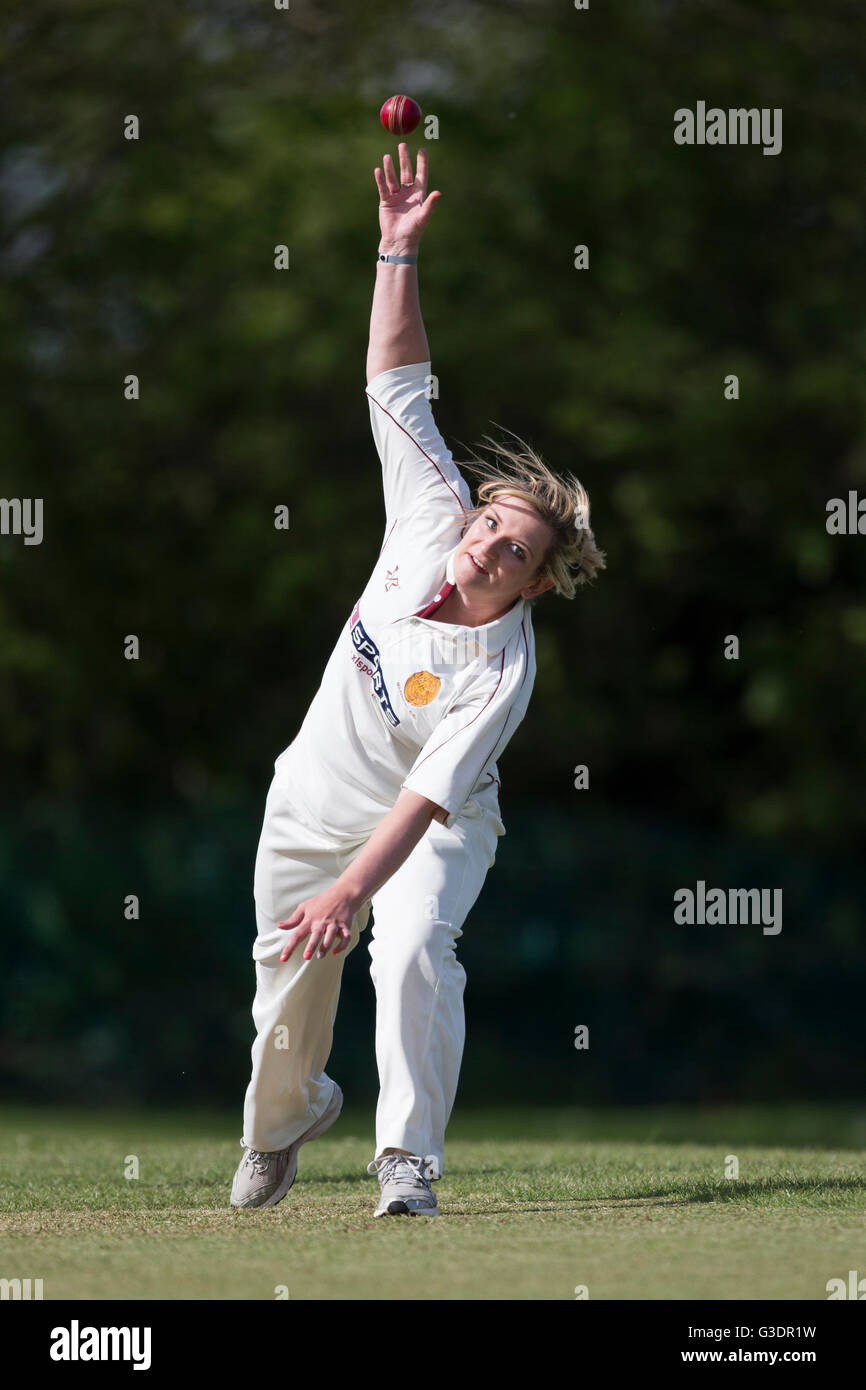 Female cricketer bowling Stock Photo