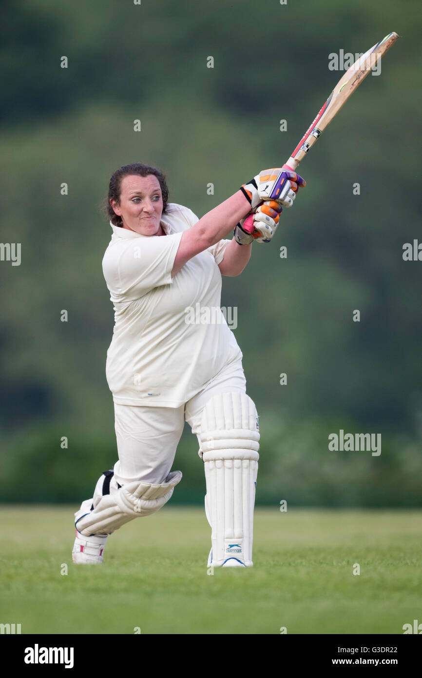 female cricket batsman in action Stock Photo