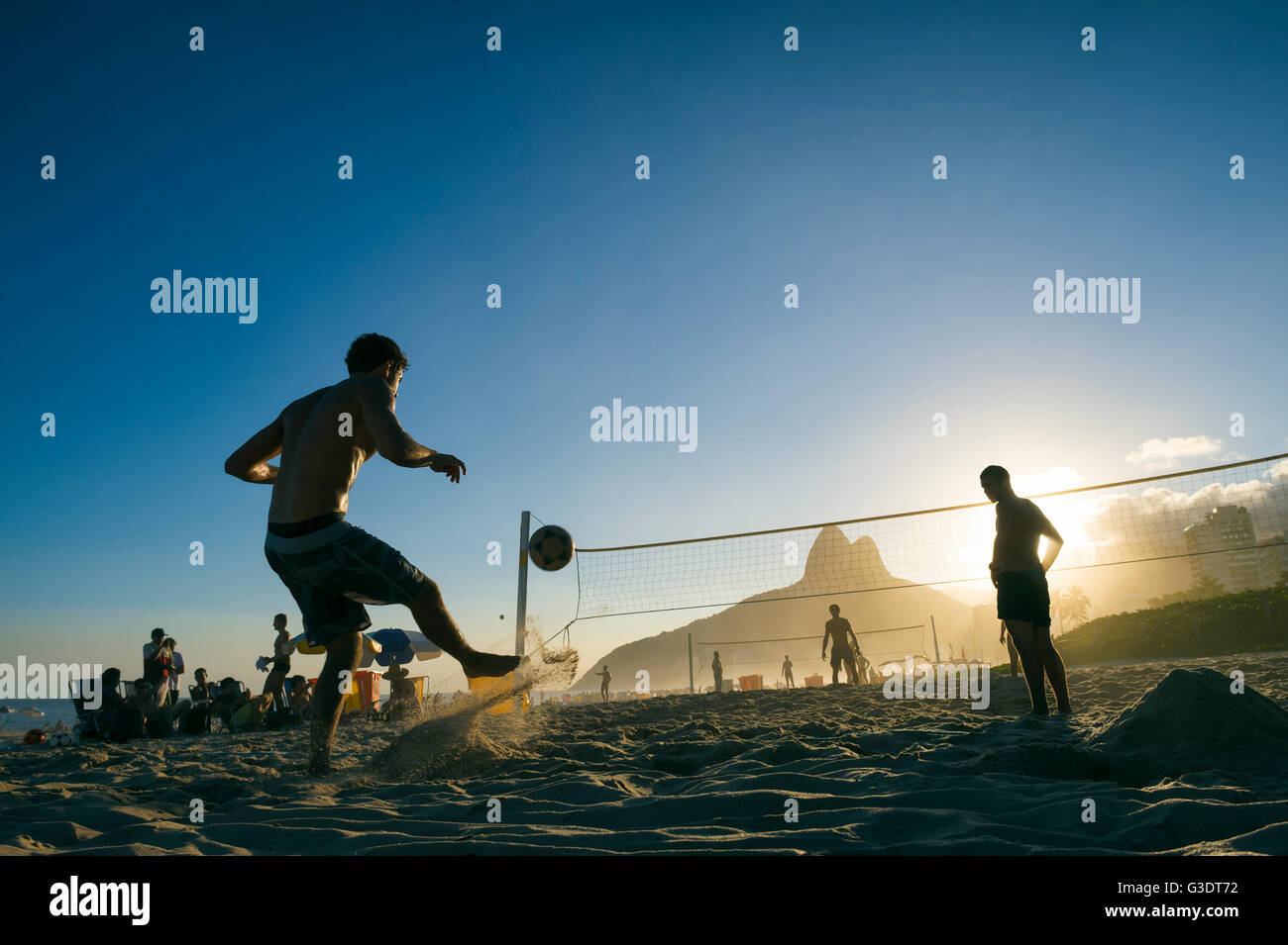 RIO DE JANEIRO - MARCH 27, 2016: Brazilians play futevôlei (footvolley, a sport combining football/soccer and volleyball). Stock Photo