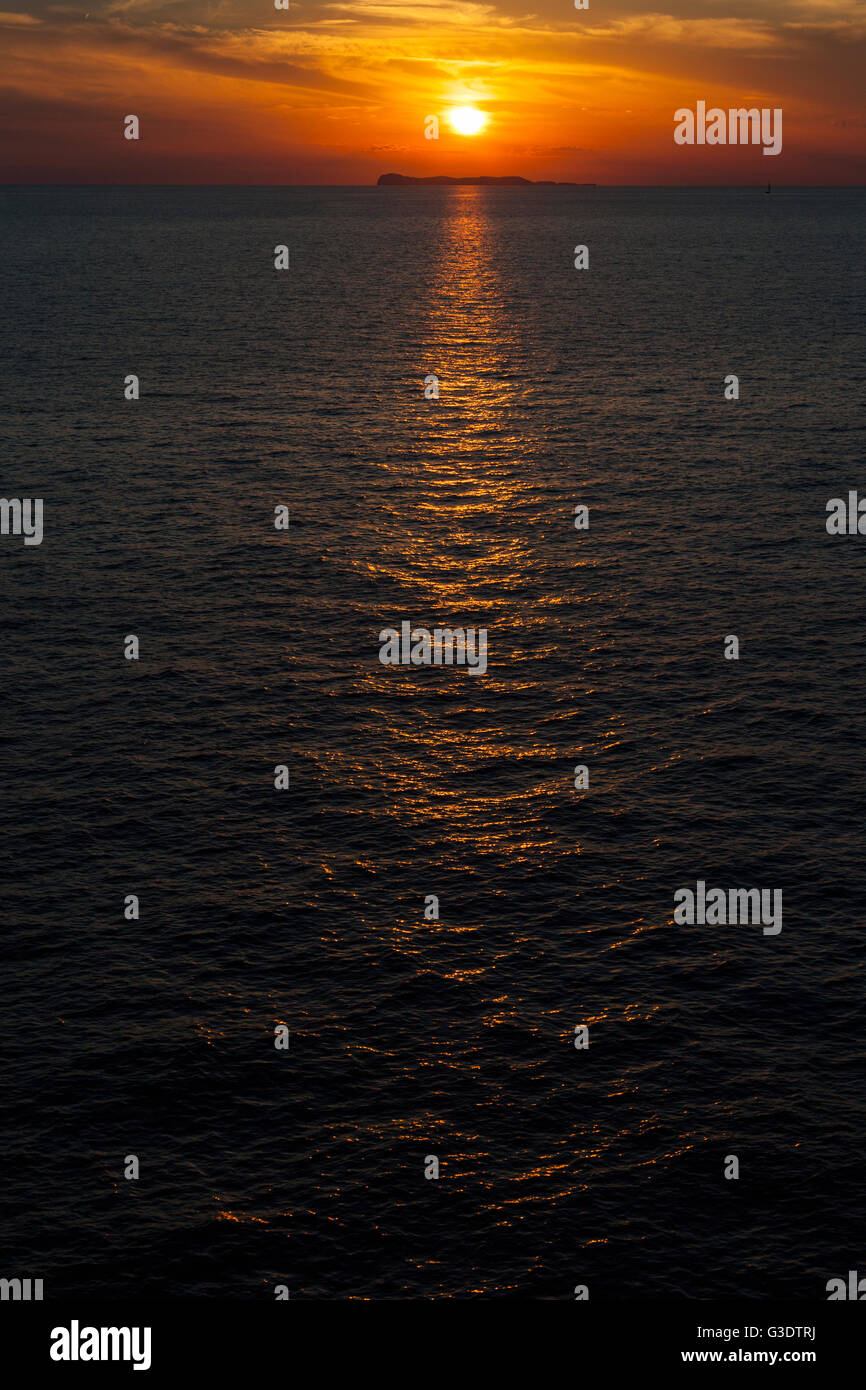 Sunset reflecting in the sea Stock Photo - Alamy