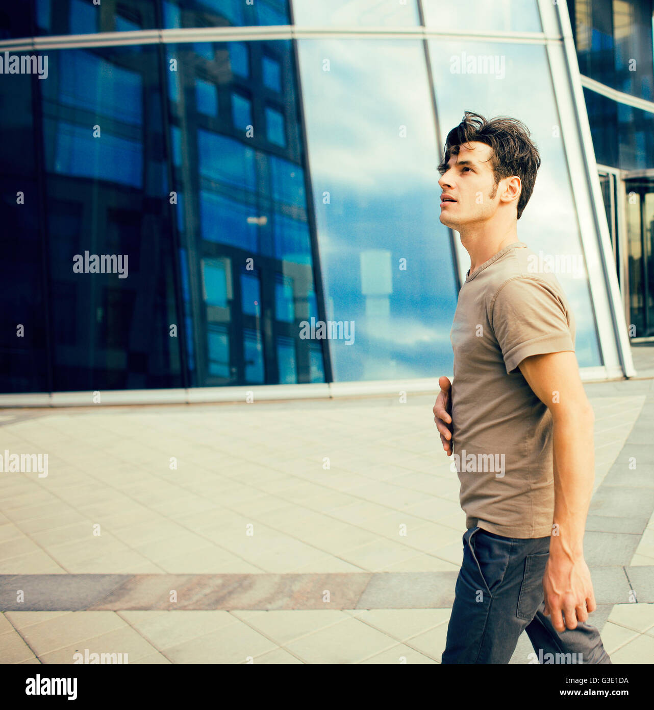 Man In Building real young man stand in front of modern business building Stock Photo ...