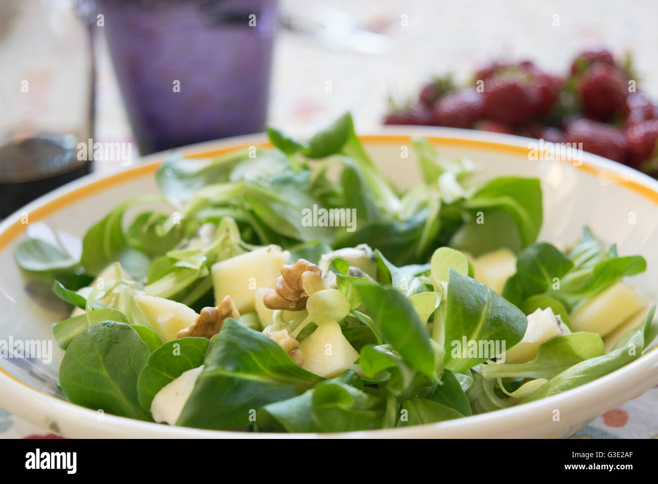 valerian salad with walnuts in a white dish Stock Photo