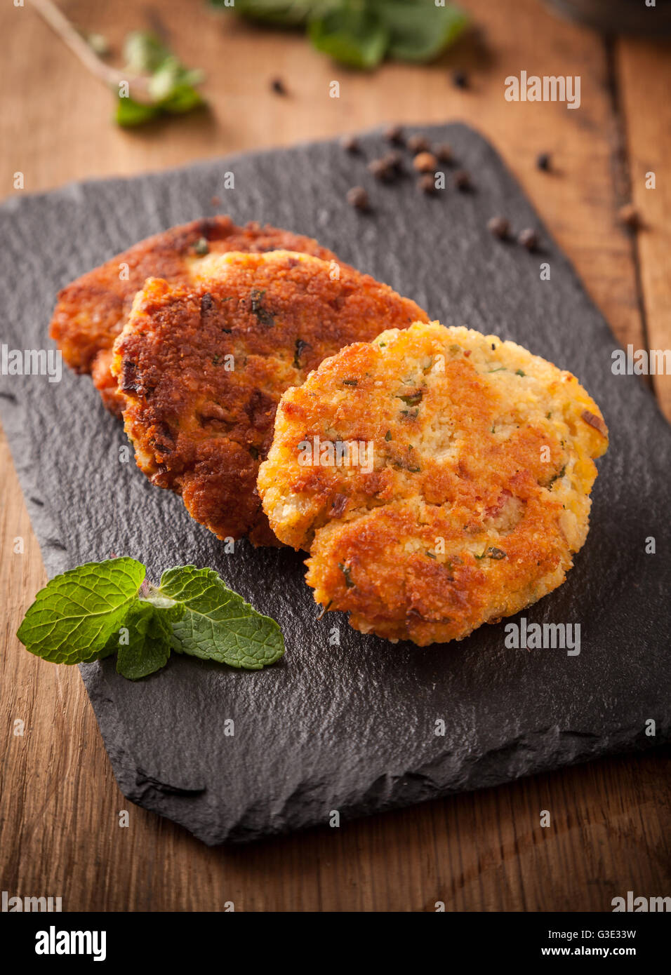 Veggie burgers on slate with mint, pepper and herbs on a slate. Stock Photo