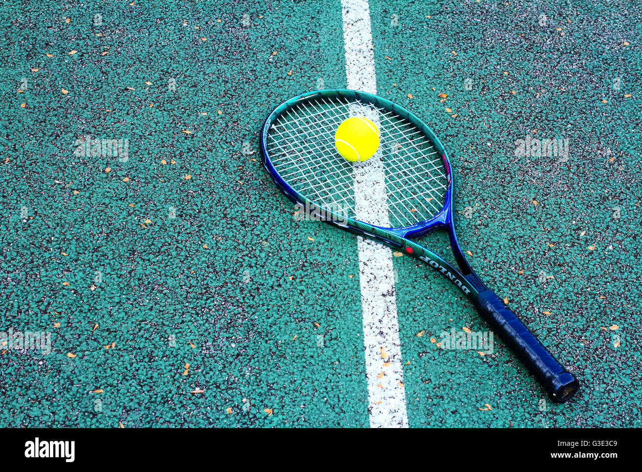 Tennis racket and tennis ball on a hard tennis court Stock Photo Alamy
