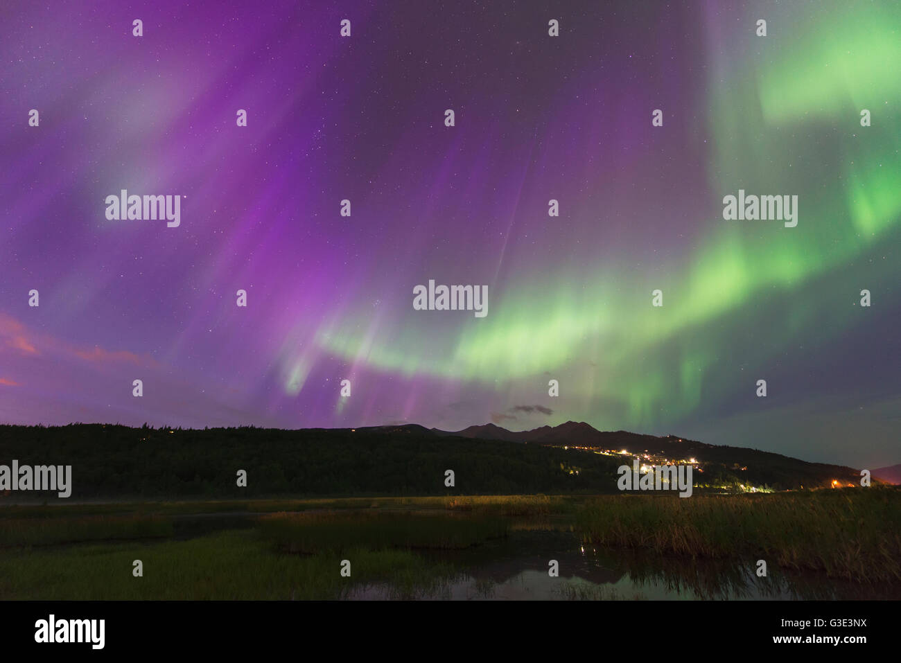 The aurora borealis over the Potter Valley neighborhood and Potter Marsh in south Anchorage, Alaska. Stock Photo