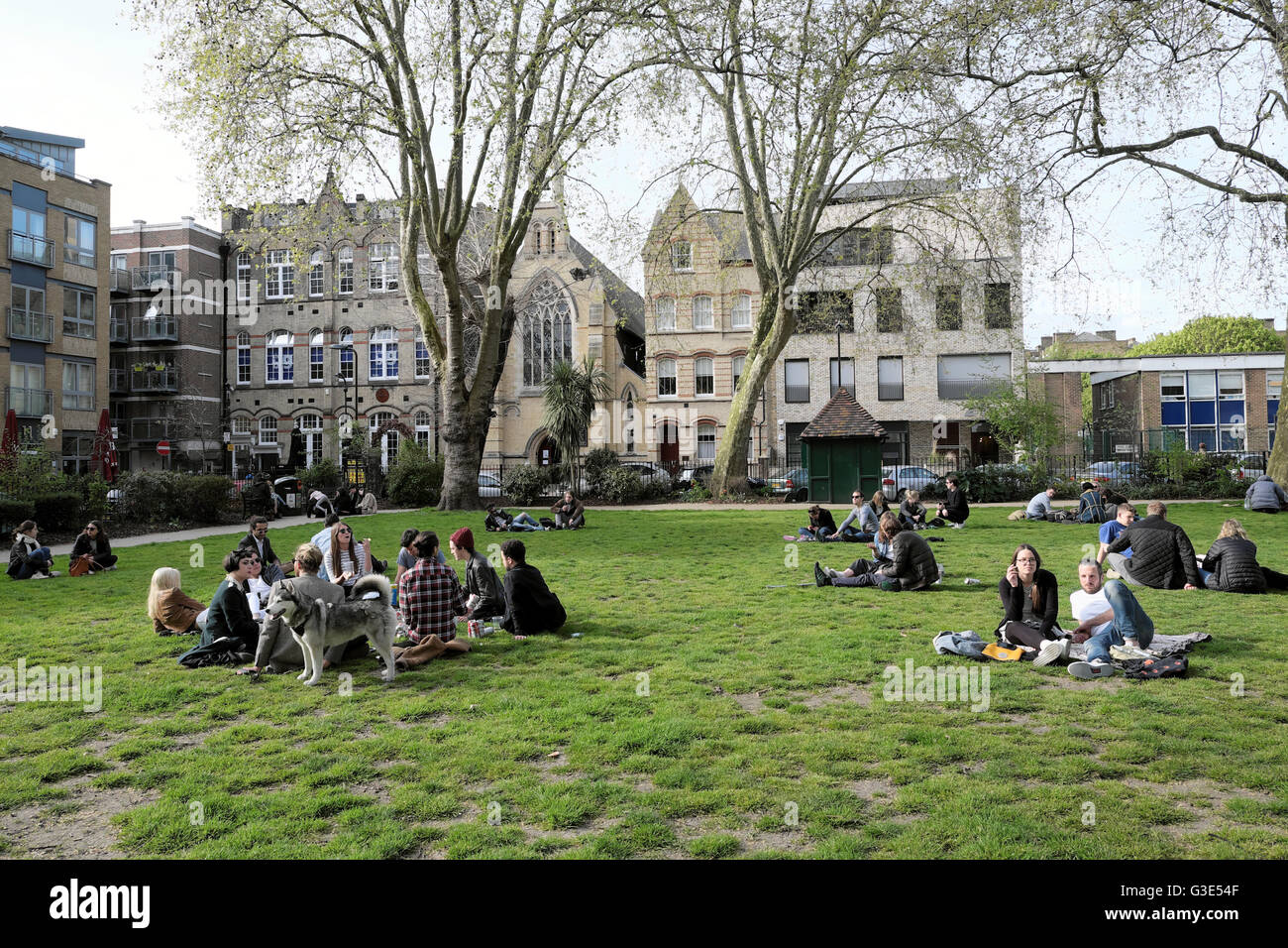 People relaxing in Hoxton Square in early spring 2016  East London, England UK  KATHY DEWITT Stock Photo