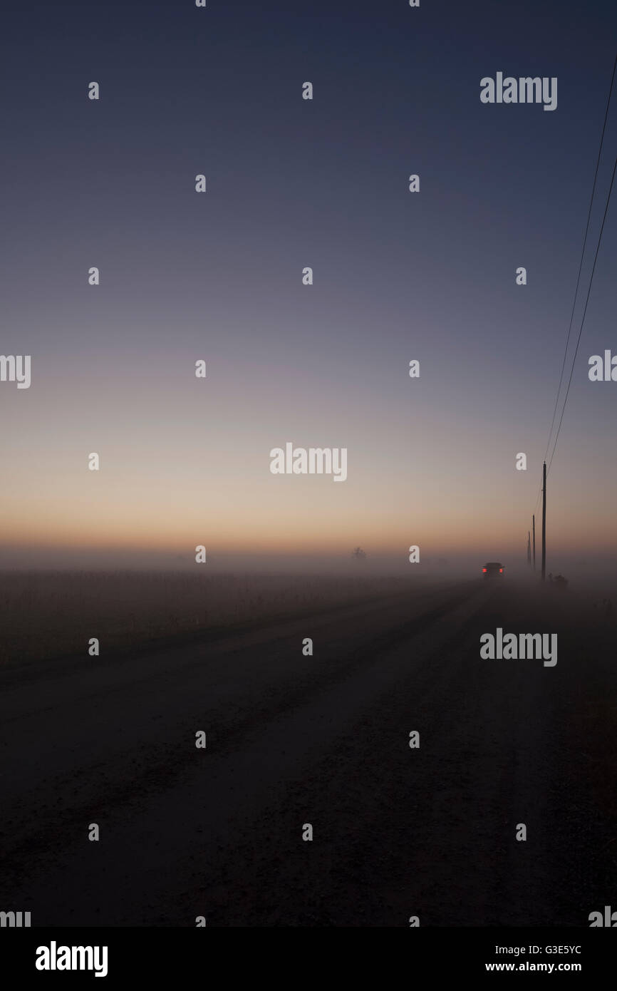 Woolwich Guelph townline before sunrise on a foggy morning; Mosborough, Ontario, Canada Stock Photo