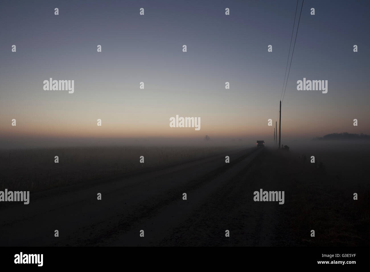Woolwich Guelph townline before sunrise on a foggy morning; Mosborough, Ontario, Canada Stock Photo