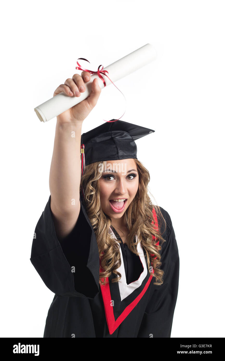 Young woman graduate holding her diploma up in celebration of her graduation; Edmonton, Alberta, Canada Stock Photo