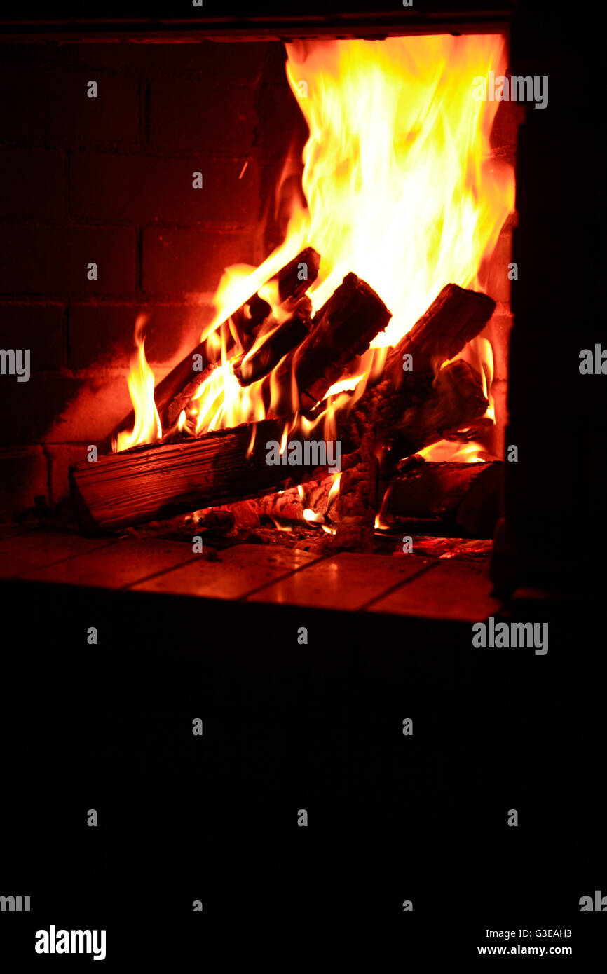 Flame background. Firewood burning in fireplace Stock Photo Alamy