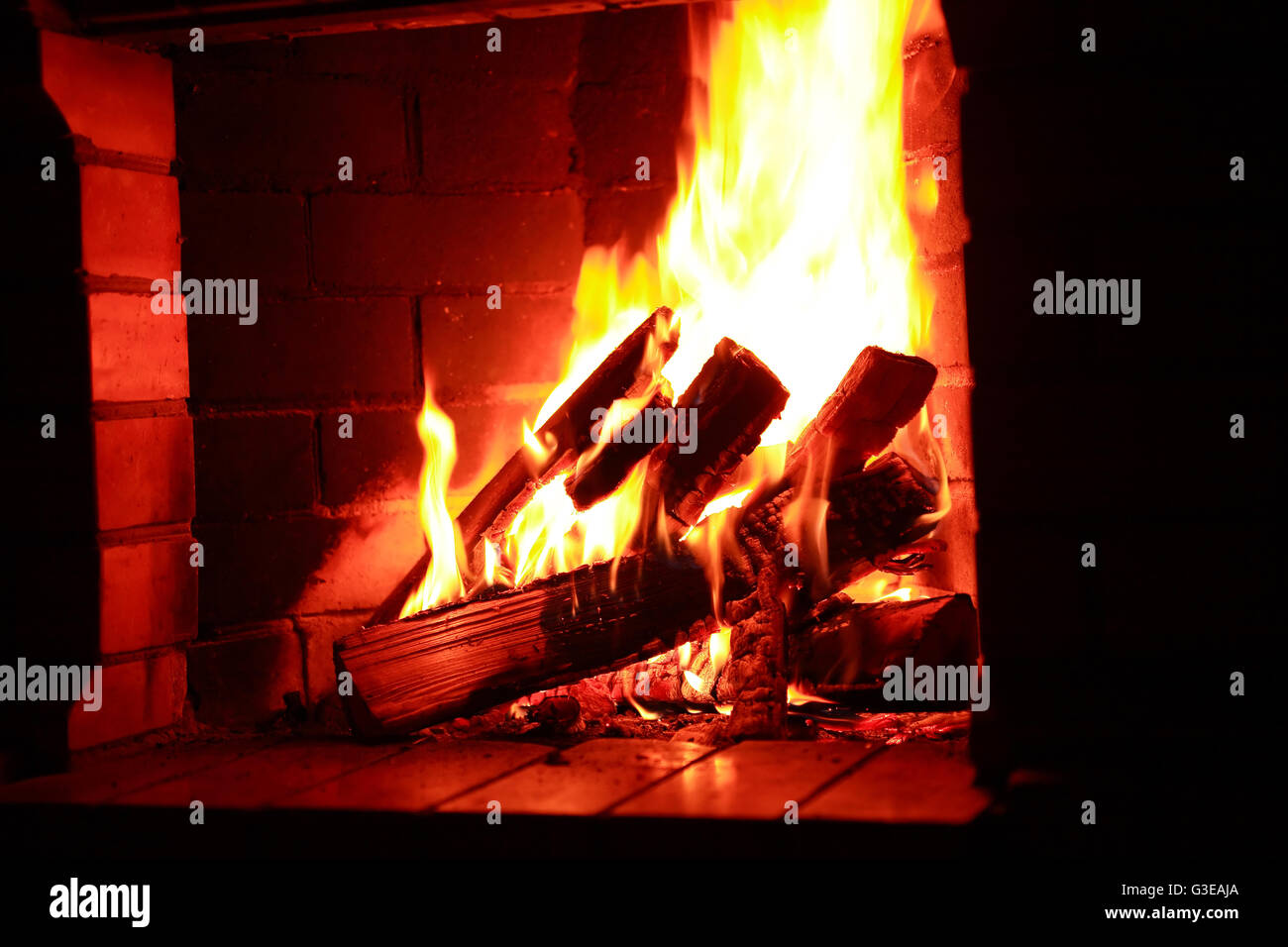 Flame background. Firewood burning in fireplace Stock Photo Alamy