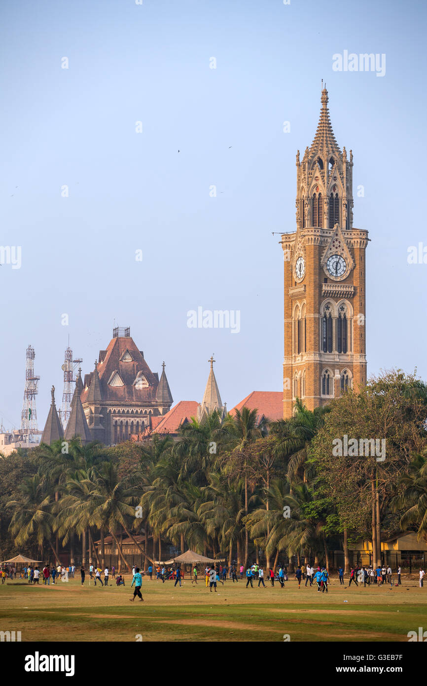 Rajabai clock tower in gothic style and green cricket field in Mumbai, Maharashtra, India Stock Photo