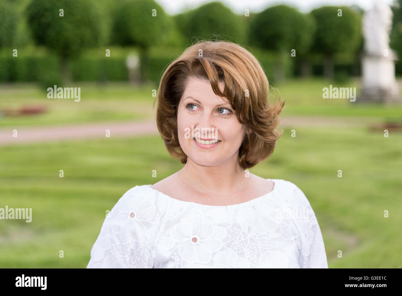 Portrait of a positive woman in a white blouse Stock Photo
