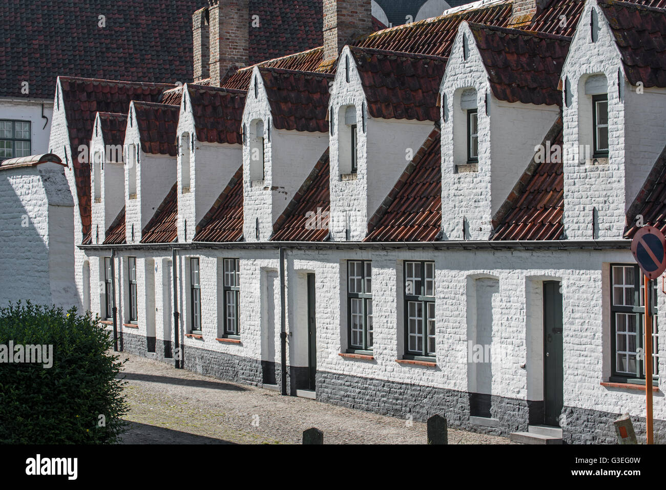Alley with medieval almshouses in Bruges, West Flanders, Belgium Stock Photo