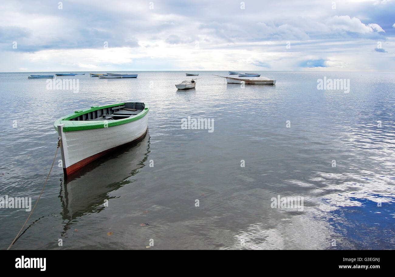 Boat with reflection on ocean surface Stock Photo