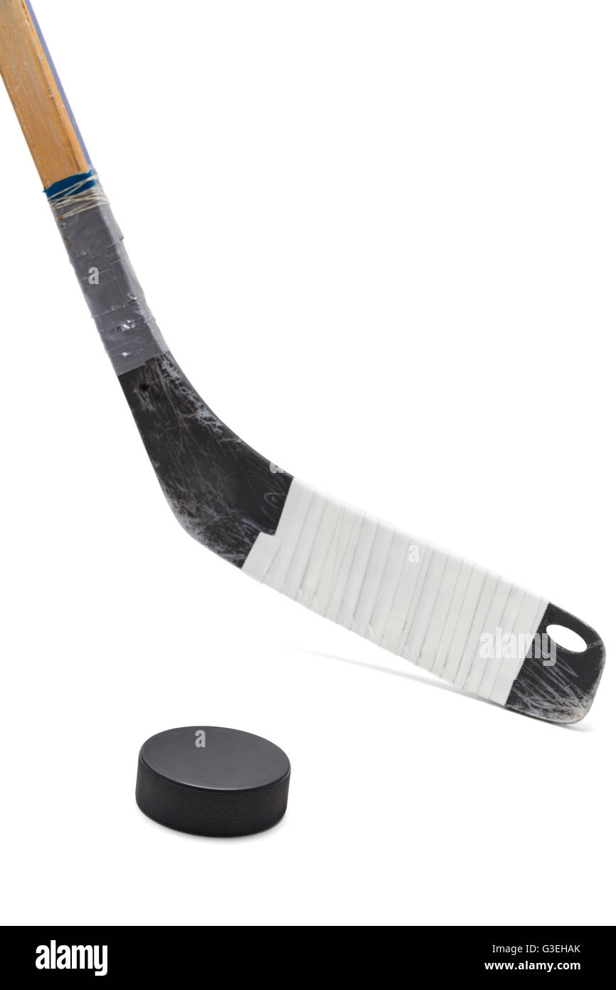 Ice Hockey Stick with Black Puck Isolated on White Background. Stock Photo