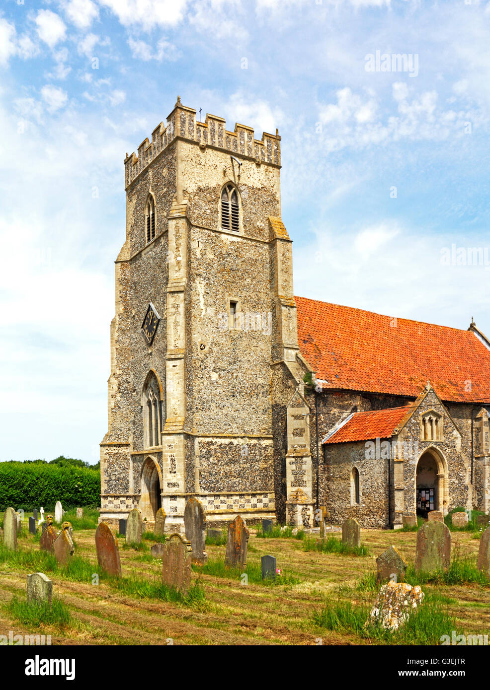 A view of the tower and south porch of the church of St Saint Martin at Thompson, near Watton, Norfolk, England, United Kingdom. Stock Photo