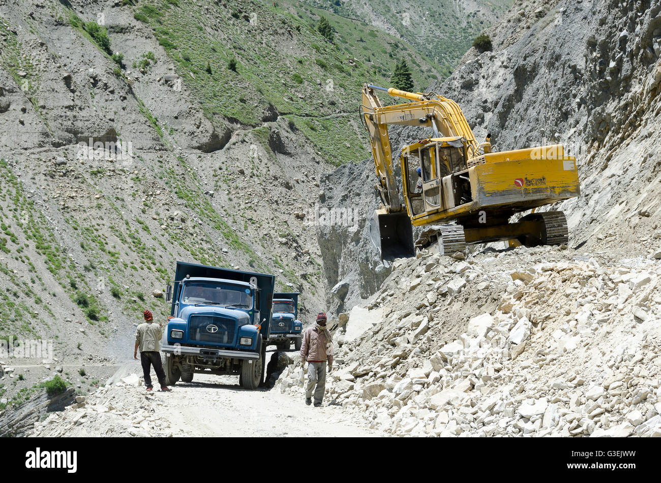 Road works with excavator and trucks, near Sissu, Manali - Leh Road, Himachal Pradesh, India, Stock Photo