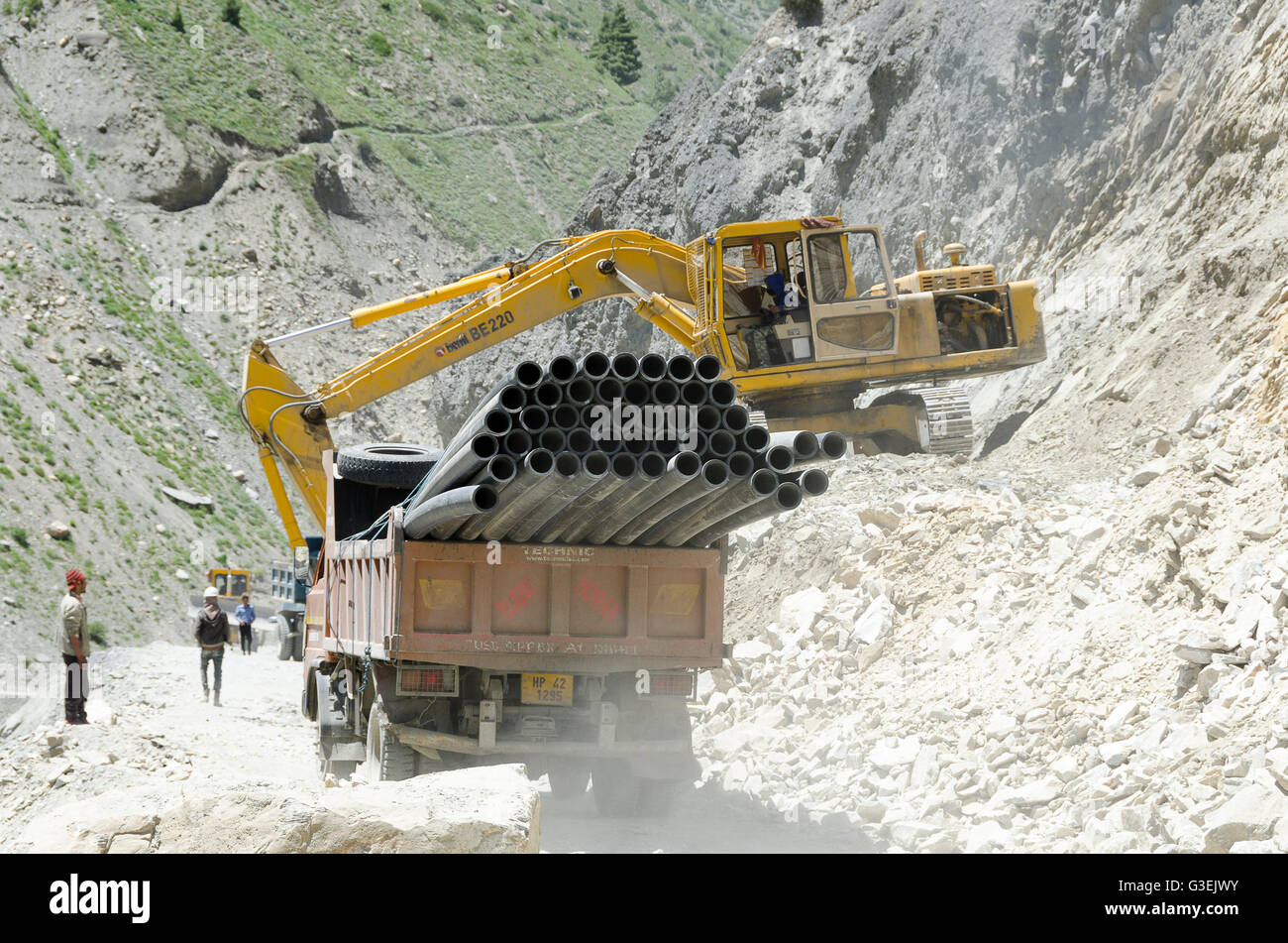 Road works with excavator and trucks, near Sissu, Manali - Leh Road, Himachal Pradesh, India, Stock Photo