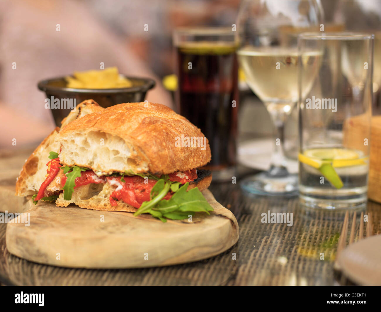 Vegetarian Italian Style Red Pepper Ciabatta Bread Sandwich With Glass  White Wine On Wooden Serving Board Stock Photo