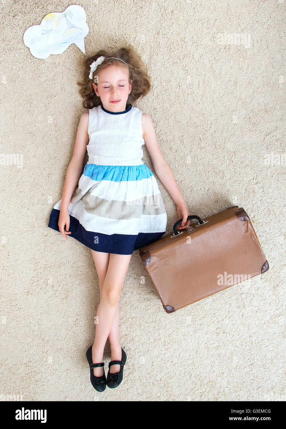 Little girl lying on the carpet and dreaming about vacation Stock Photo ...