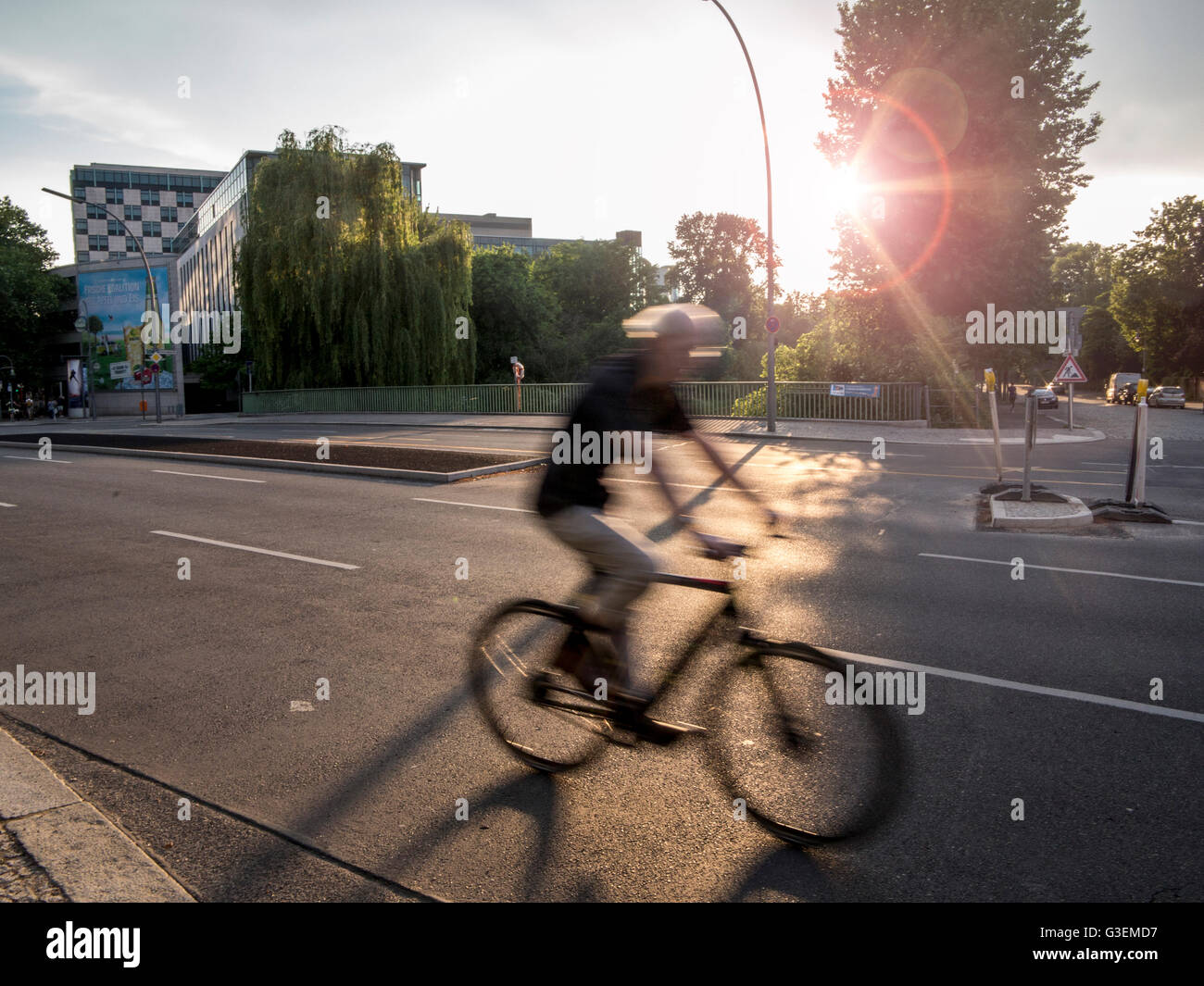 Cyclist in Berlin in the early evening sunshine Stock Photo