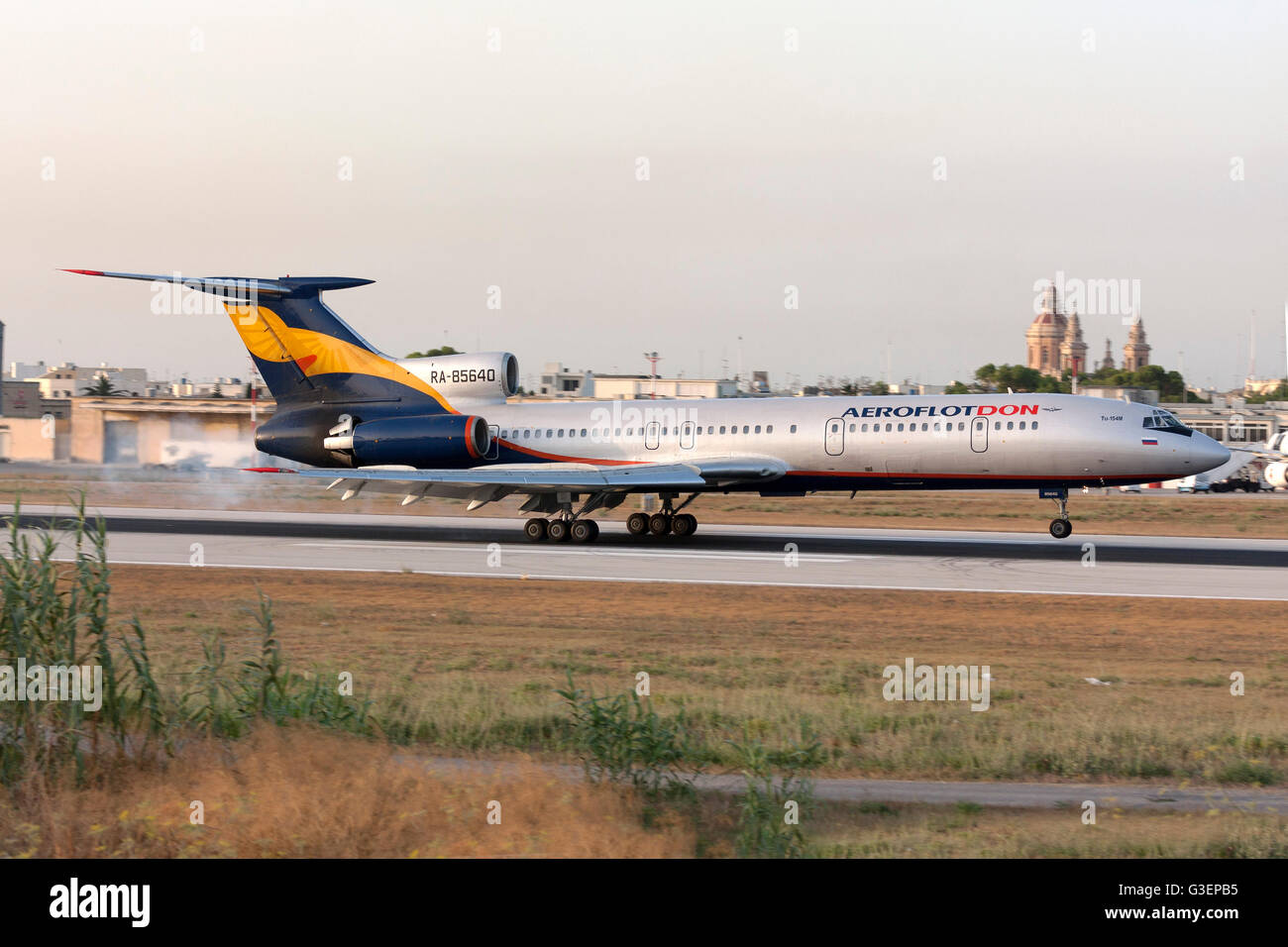 Aeroflot-Don Tupolev Tu-154M landing runway 14, just as the sun is about to set. Stock Photo