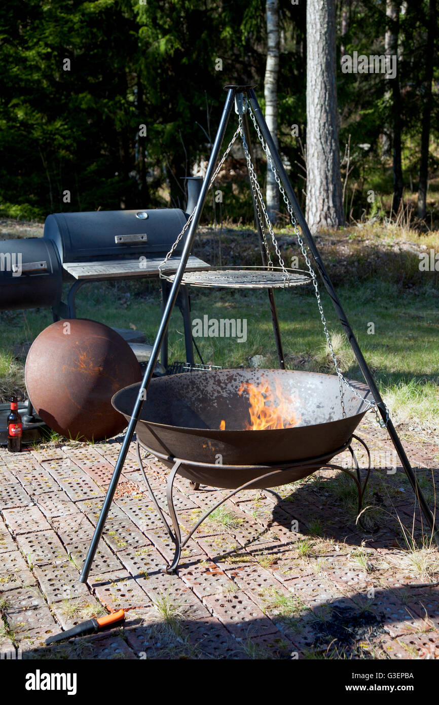 Tripod Swivel Grill Barbecue in the forest Stock Photo