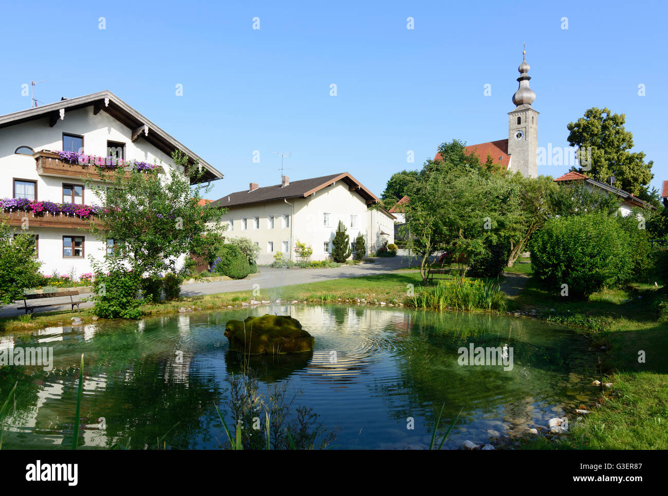 Village pond and church in Törring, Germany, Bayern, Bavaria, Oberbayern, Rupertiwinkel, Upper Bavaria, Tittmoning Stock Photo