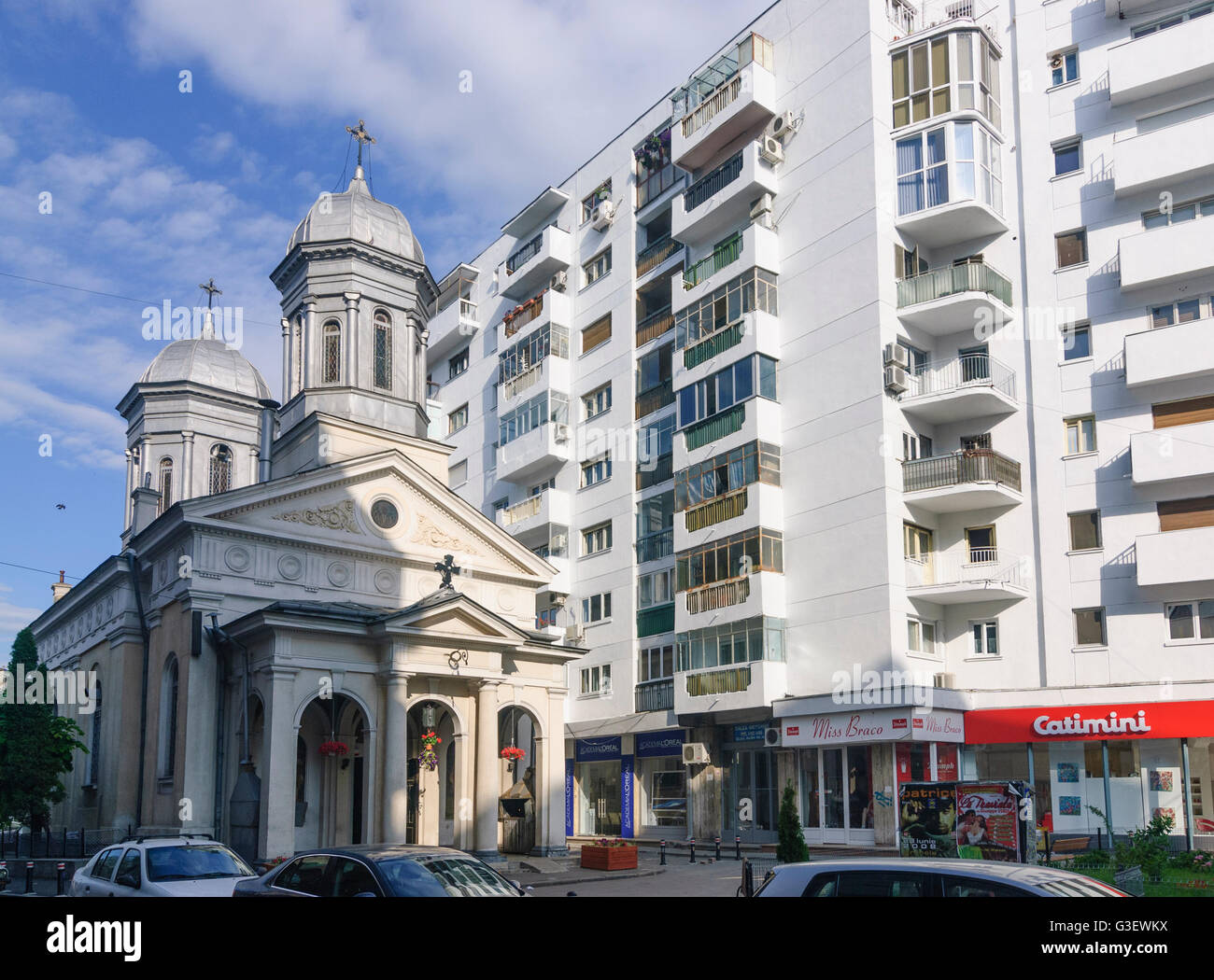 Church next to residential buildings, Romania Bucharest Bucuresti Stock Photo