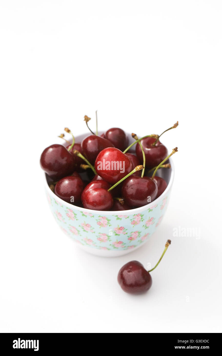 Fresh cherries in a bowl on a white background. Stock Photo