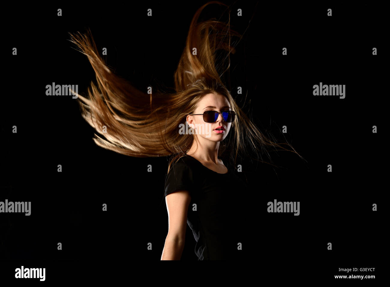 Teenage girl with streaming hair and sunglasses Stock Photo