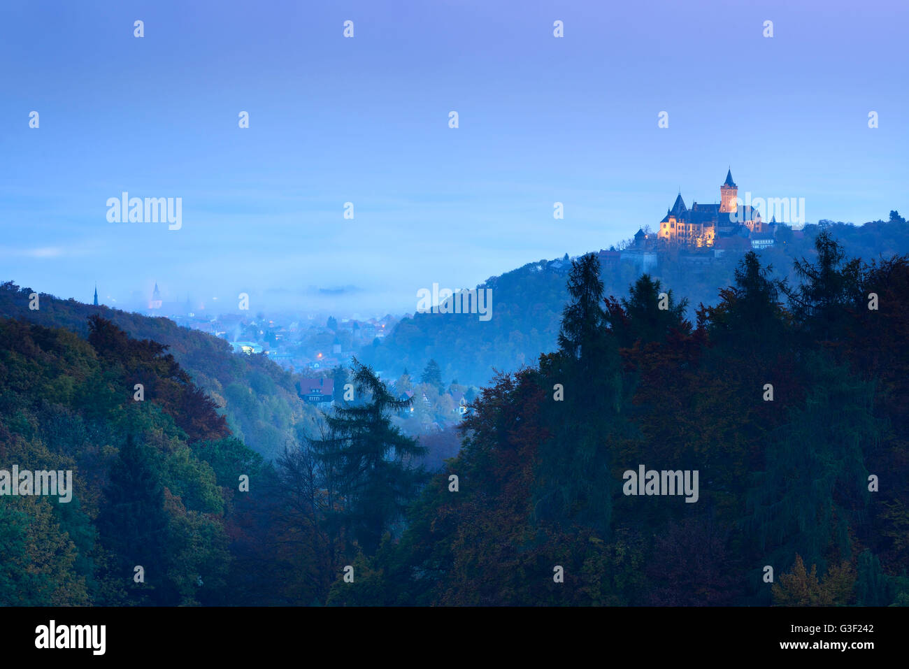 Town and castle Wernigerode at daybreak, in the background morning fog, Wernigerode, Saxony-Anhalt, Germany Stock Photo