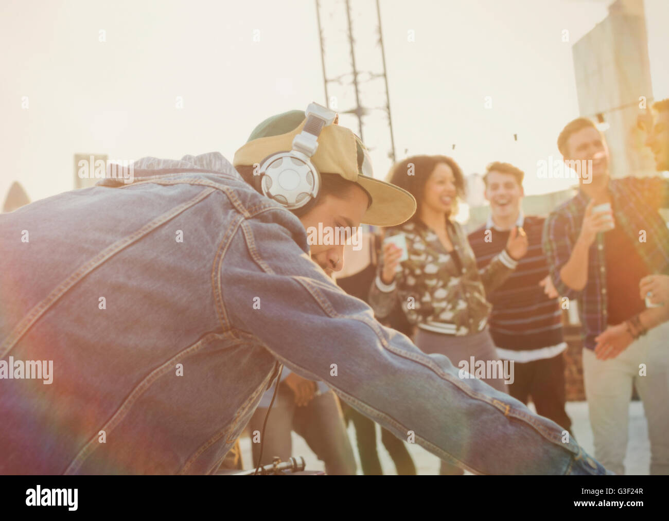 DJ with headphones at rooftop party Stock Photo Alamy