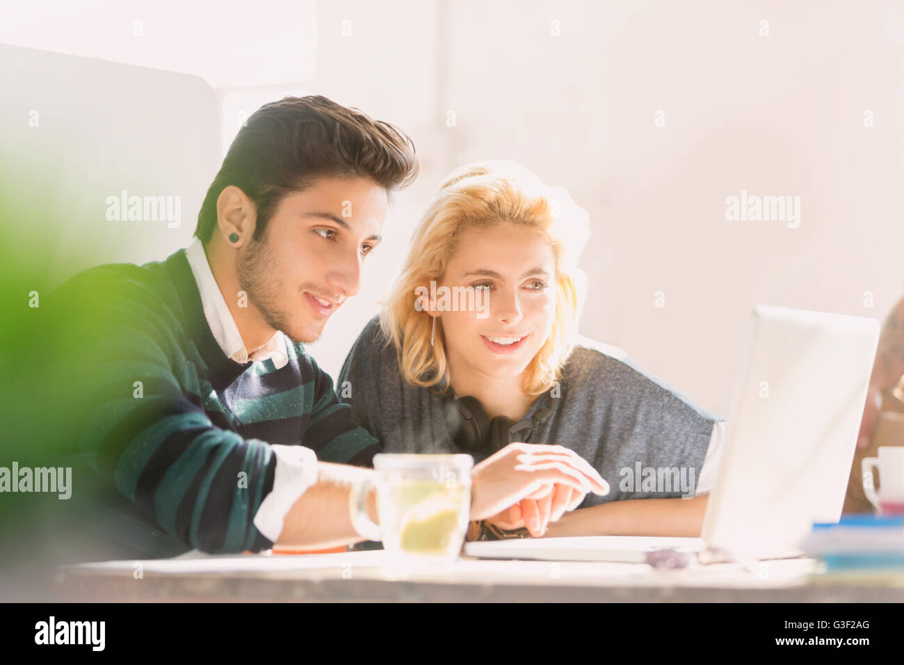 Creative young business people working at laptop Stock Photo