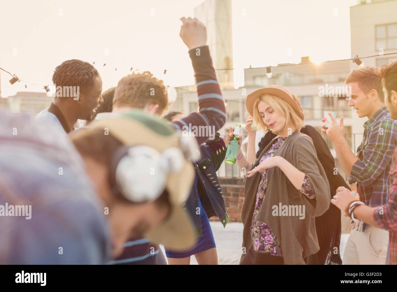 Young adult friends dancing at rooftop party Stock Photo
