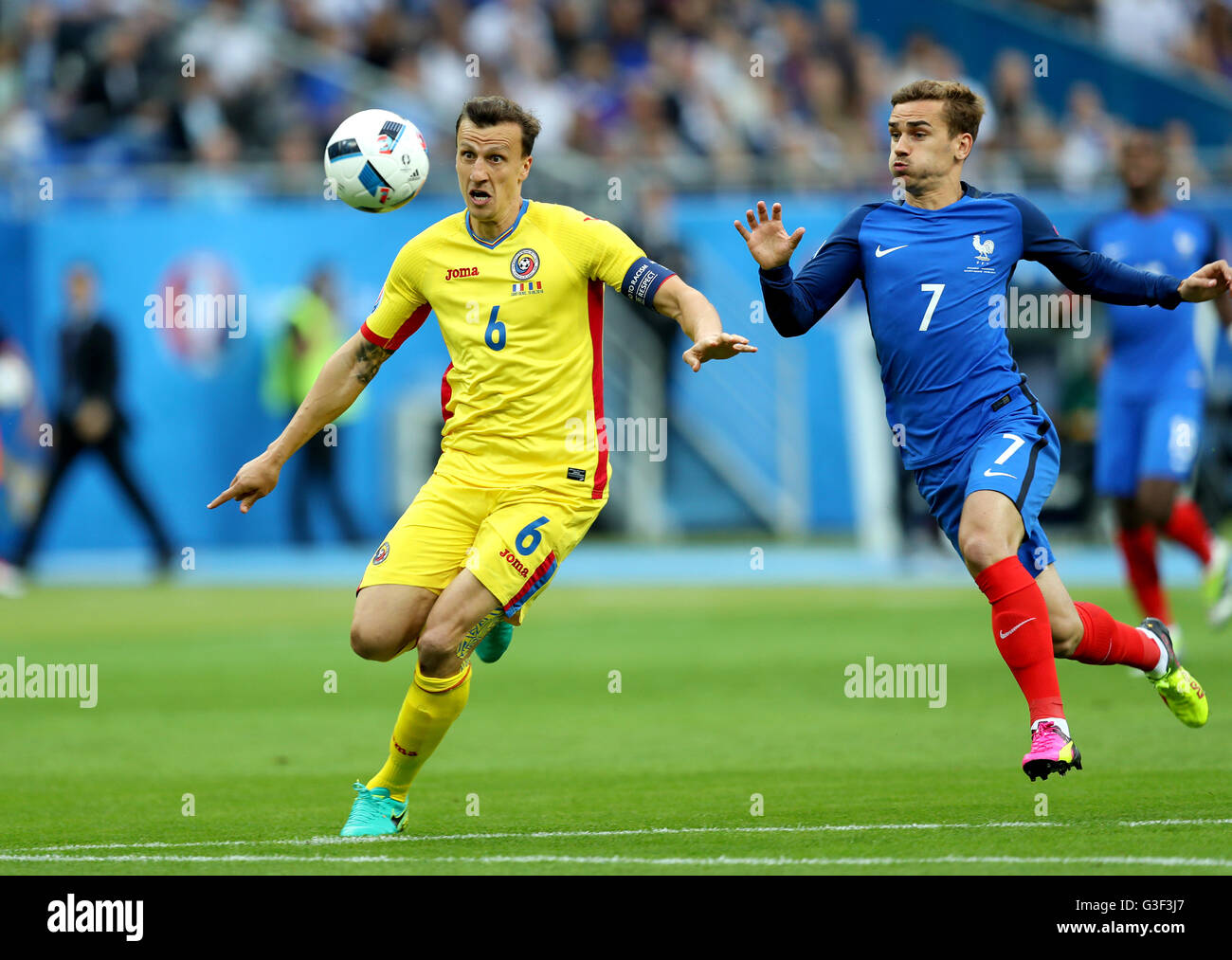 Romania's Vlad Chiriches (left) and France's Antoine Griezmann in action during the UEFA Euro 2016, Group A match at the Stade de France, Paris. Stock Photo
