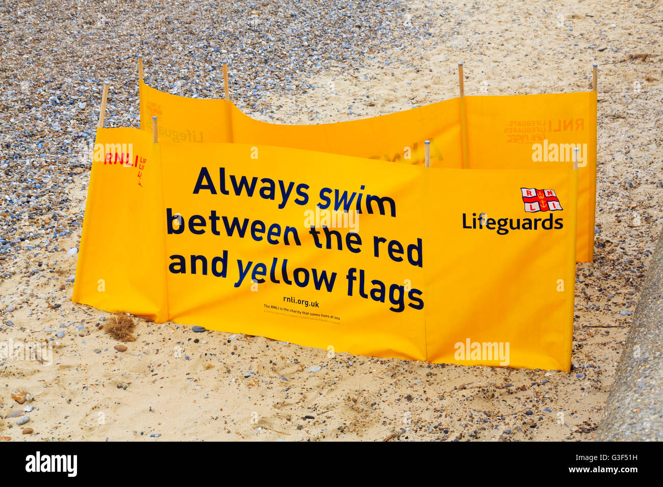 RNLI warning banners denoting safe swimming areas, Southwold, Norfolk, England Stock Photo