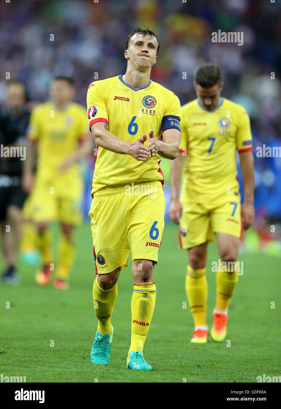 Romania's Vlad Chiriches looks dejected as he applauds the fans after the UEFA Euro 2016, Group A match at the Stade de France, Paris. Stock Photo