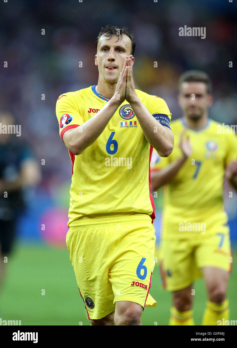 Romania's Vlad Chiriches looks dejected as he applauds the fans after the UEFA Euro 2016, Group A match at the Stade de France, Paris. Stock Photo