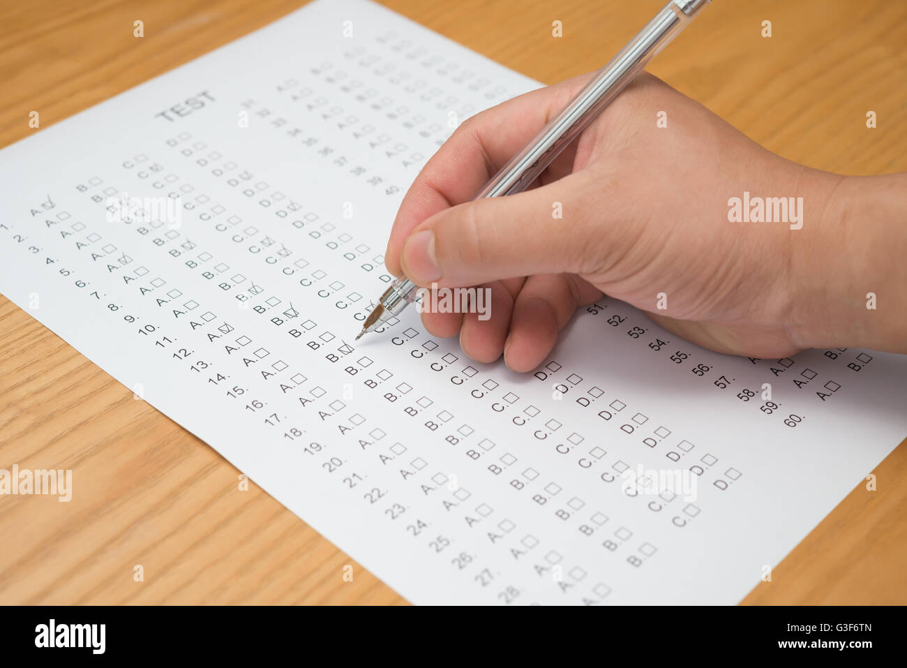 filling test score sheet with ballpoint Stock Photo