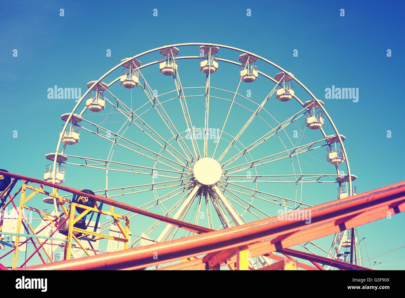 Vintage toned picture of an amusement park. Stock Photo