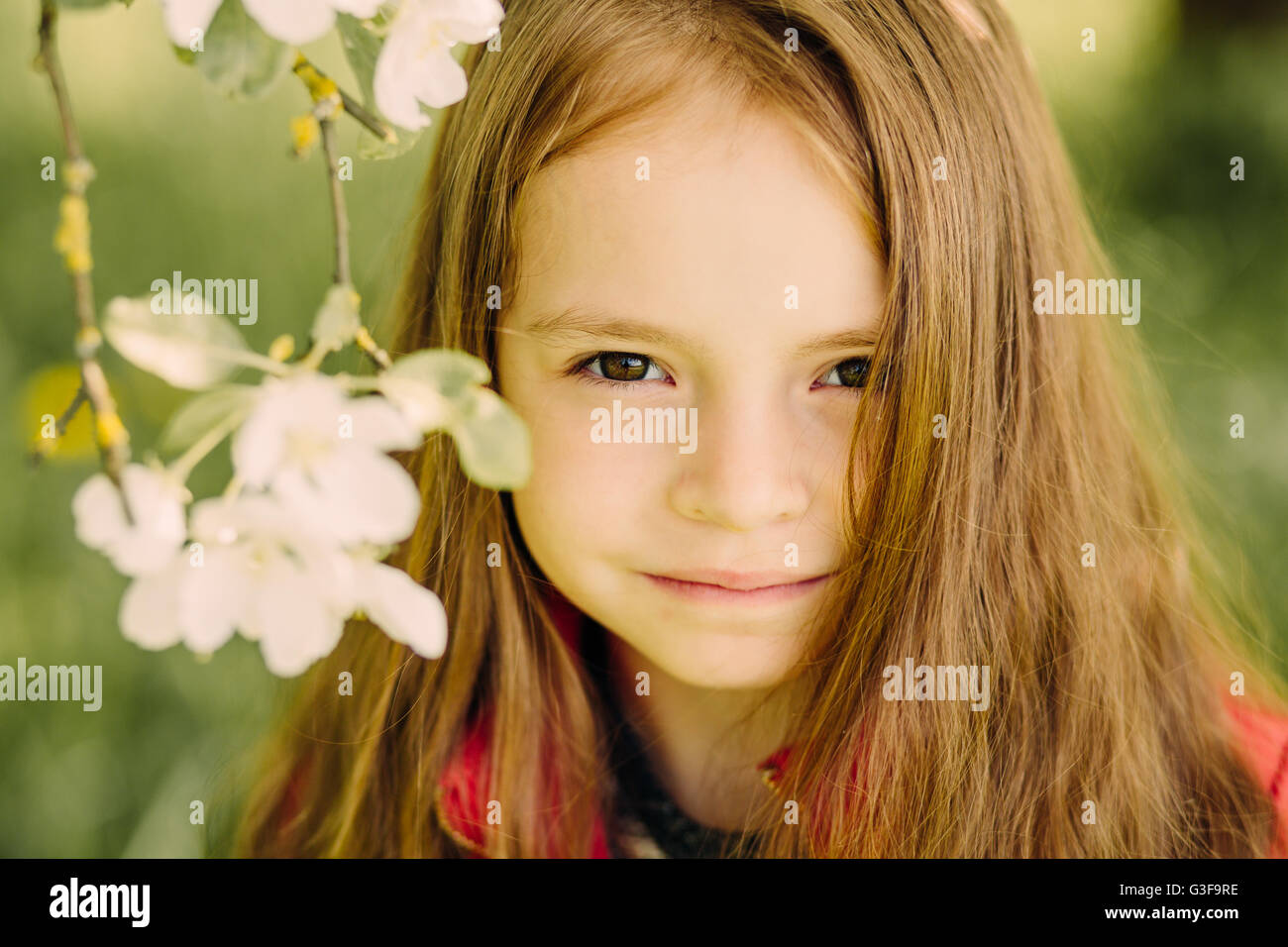Portrait of little cute beautiful girl in garden Stock Photo - Alamy