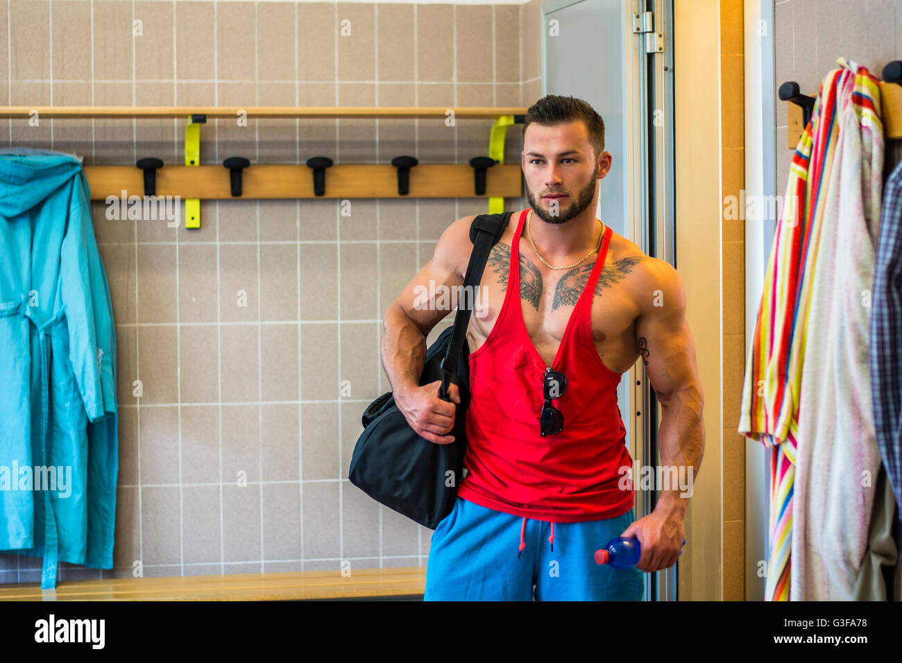 Portrait of handsome man in dressing room with sportsbag Stock Photo