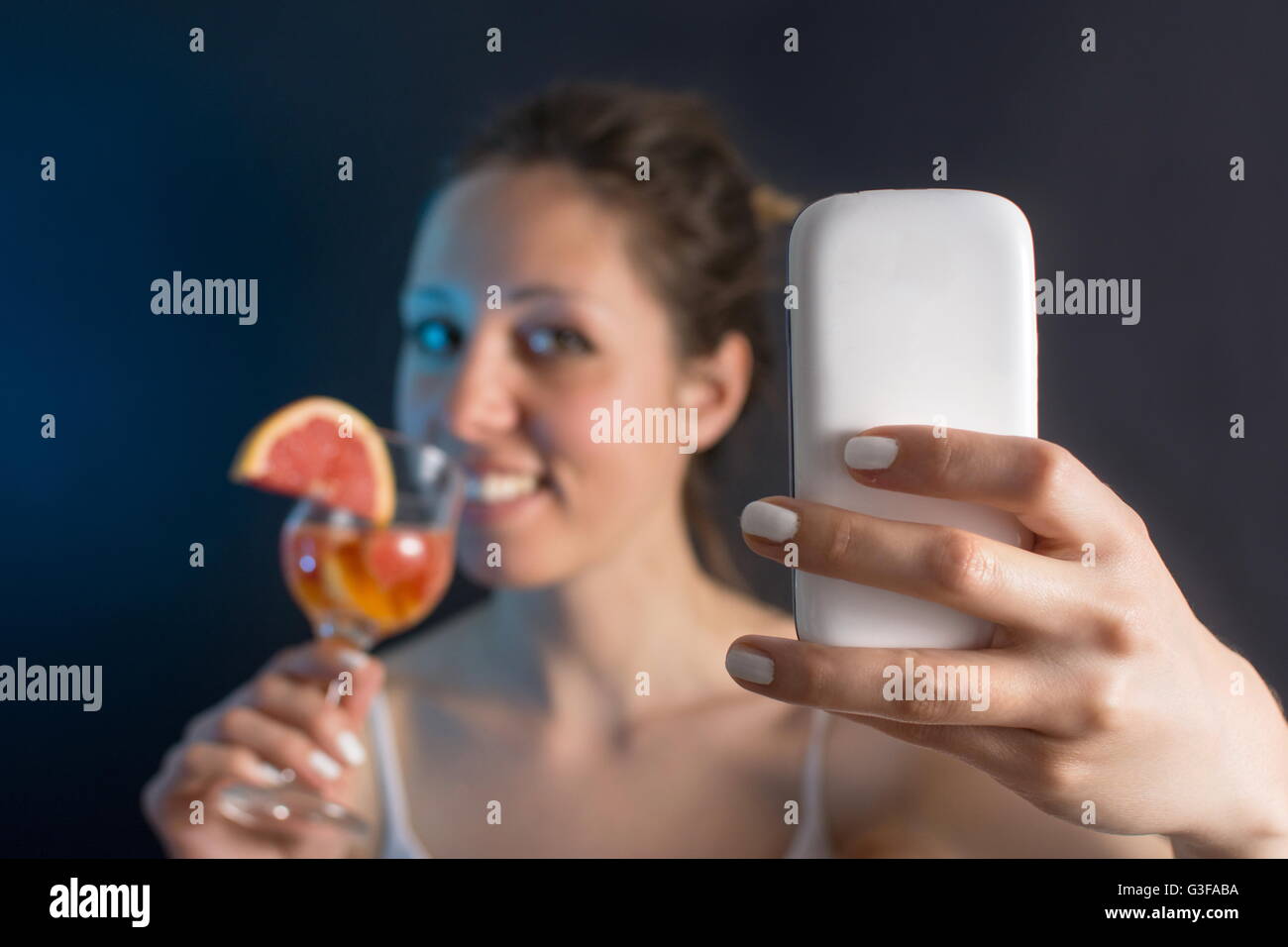 Young woman  making a selfie with a cocktail Stock Photo
