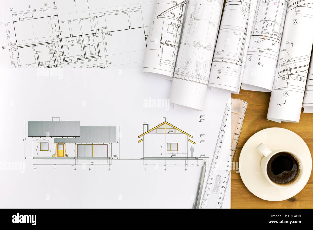 coffee cup and architectural blueprints on working table Stock Photo