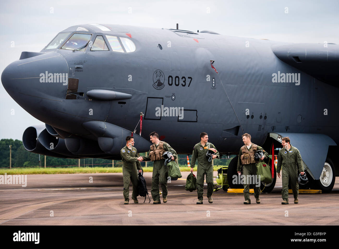 Crew members of a United States Air Force (USAF) Boeing B-52H Stratofortress strategic bomber of the 23d Bomb Squadron, parked on the pan at RAF Fairford airbase, as part of a US Air Force Global Strike Command deployment to Fairford, for military training exercises. Stock Photo