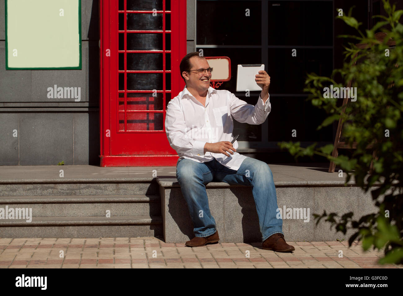Man Using Red Telephone Business man using mobile phone red classic English telephone box Stock ...